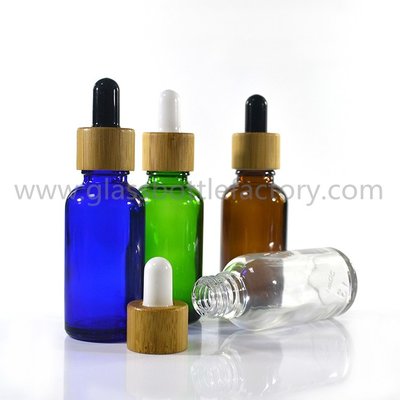 China 30ml Clear,Amber,Blue,Green Round Essential Oil Glass Bottles With Bamboo Droppers supplier