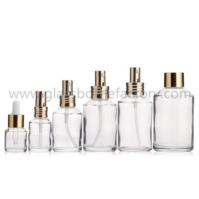 China 15ml,30ml,60ml,100ml,120ml,200ml Clear Sloping Shoulder Glass Lotion Bottles With Pumps supplier